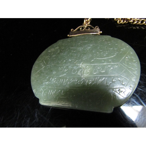 6194 - A large jade pendant with script, 5cm x 6cm hung on an unmarked gold chain, 46cm long, 7.4g