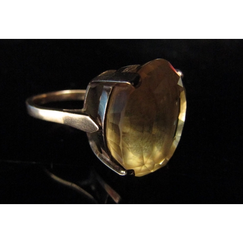 6201 - An unmarked gold ring set with a large oval citrine in high mount. Size P/Q, 8.5g