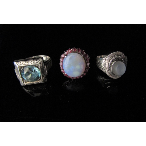 6211 - Three white metal rings including ruby and opal example. Size Q