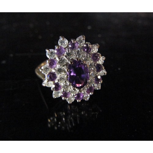 6212 - A 9ct gold amethyst and clear stone dress ring. Size O, 3.5g