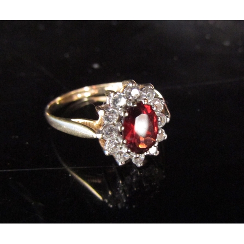 6213 - A 9ct gold garnet and cubic zirconia cluster ring. Size P, 2g      (R) £40