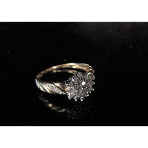 6215 - A 9ct gold diamond cluster with diamond set shoulders. Size N, 2.2g          (R) £80