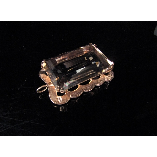 6217 - A large rectangular smoky quartz pendant/brooch in a gold framed stamped 9ct