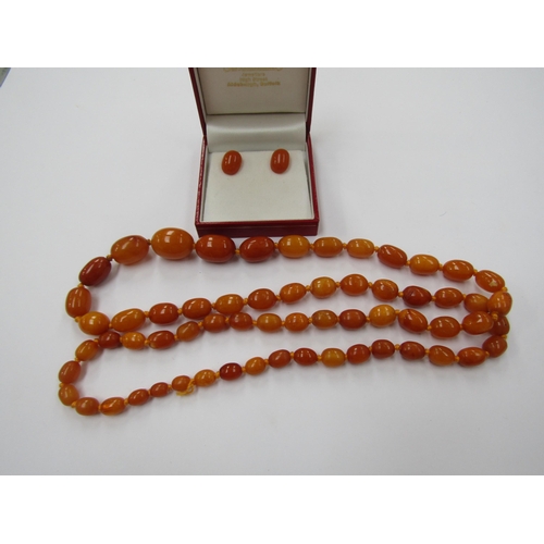 6221 - An amber bead necklace, graduated beads, 22mm x 15mm largest bead, 88cm long, 47.3g and a pair of am... 