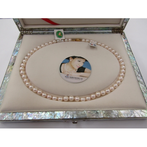 6225 - A single strand of pearls, 43cm long, in mother-of-pearl fitted box       (R) £100