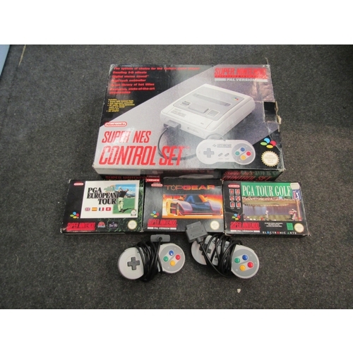 7028 - A boxed SNES Super Nintendo Entertainment System and games; PGA Tour Golf, PGA European Tour and Top... 