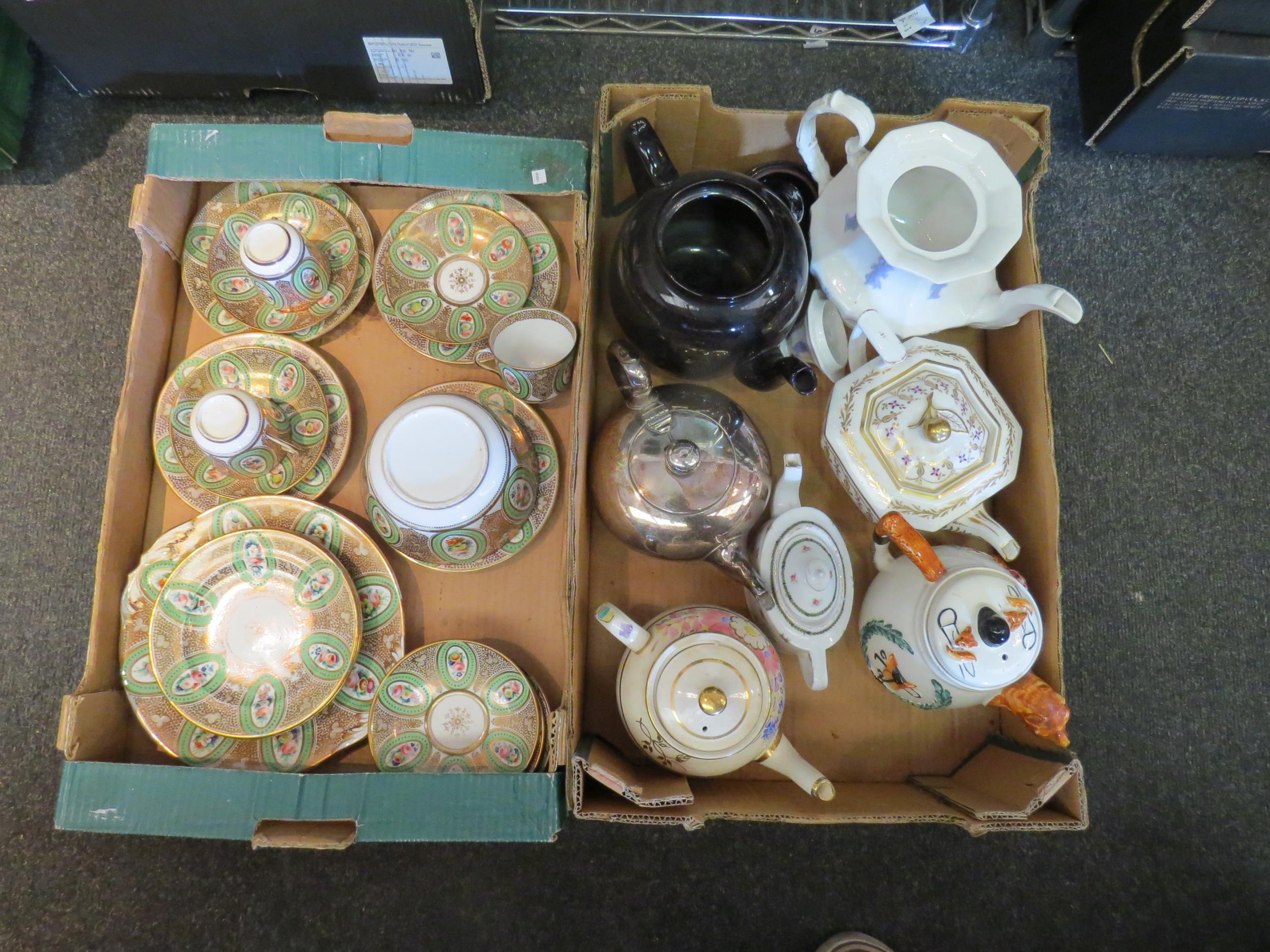 A box containing seven decorative teapots and a 19th Century green and