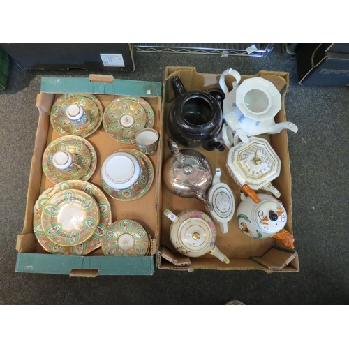 A box containing seven decorative teapots and a 19th Century green and