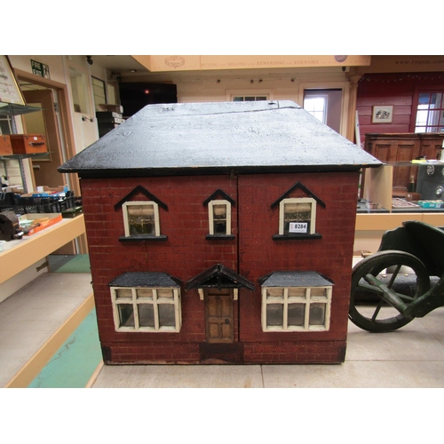 8284 - An early 20th Century front opening wooden two storey dolls house    (E) £20-30