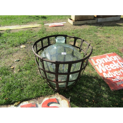 8370 - A glass carboy in metal frame