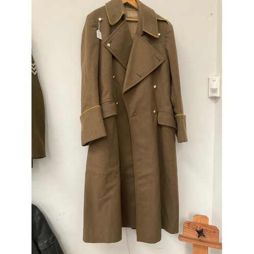 5003 - A 1950's British Army Officer's greatcoat, yellow piping, plain buttons the label marked 2nd/Lt. D.G... 