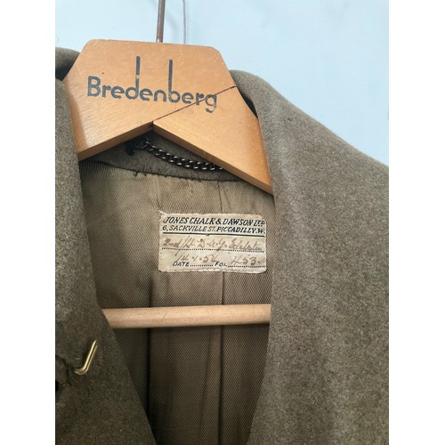 5003 - A 1950's British Army Officer's greatcoat, yellow piping, plain buttons the label marked 2nd/Lt. D.G... 