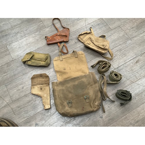 5031 - A 1958 dated British Army webbing satchel with contents including wartime cases and leather holster