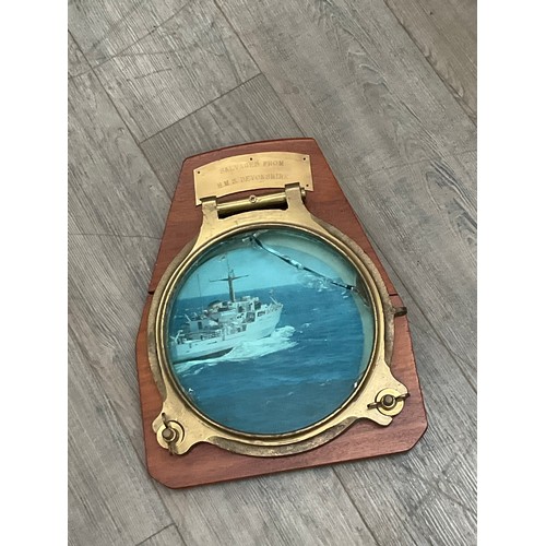 5069 - A brass porthole salivated from HMS Devonshire, mounted on plaque