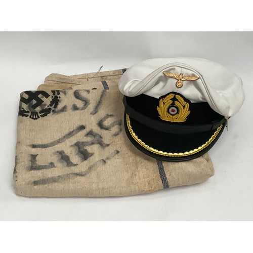 5109 - A German Navy style supply sack, possibly post-war, together with a replica U-Boat captain's peaked ... 