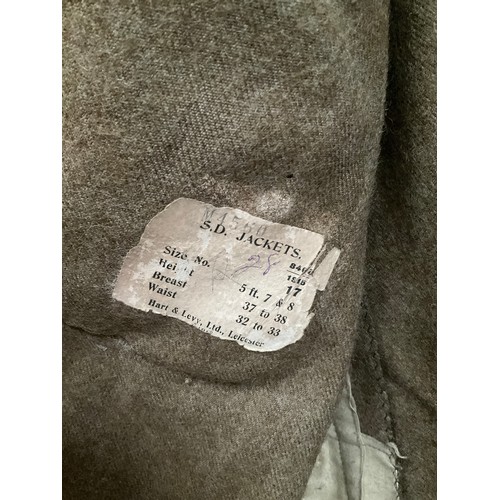 5263 - A WWI British army jacket with Suffolk shoulder titles, some moth damage, with label S.D. Jackets, d... 