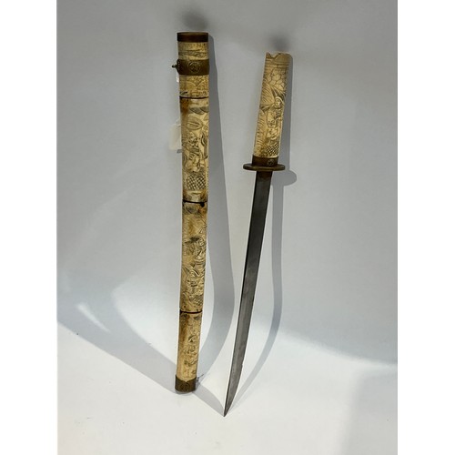 5289 - An Oriental sword with bone segmented scabbard carved with figures a/f