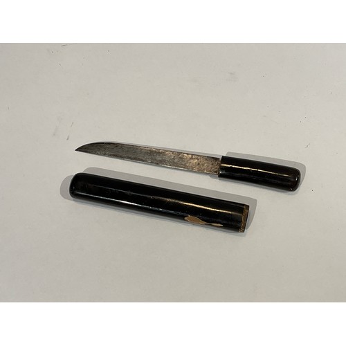 5290 - A Japanese miniature sword encased with black lacquered handle and scabbard, set with white metal de... 