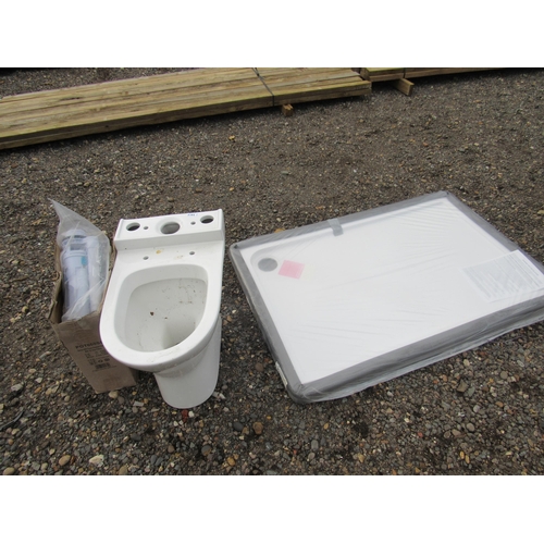 3412 - An unused still wrapped shower tray and a ceramic toilet with cistern