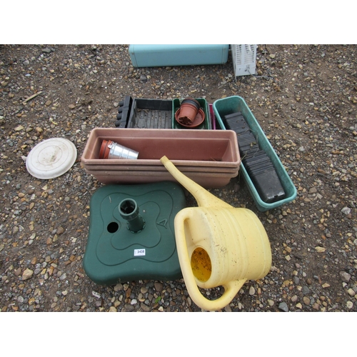 3438 - A quantity of plastic pots, a parasol stand and a watering can