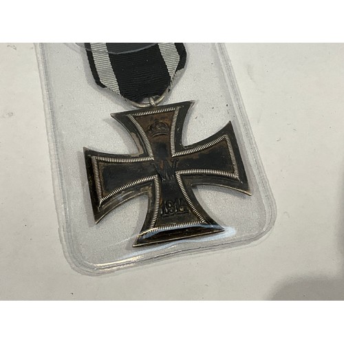 5382 - A German Iron Cross together with a selection of documents. Buyer to determine age of medal.   (C)