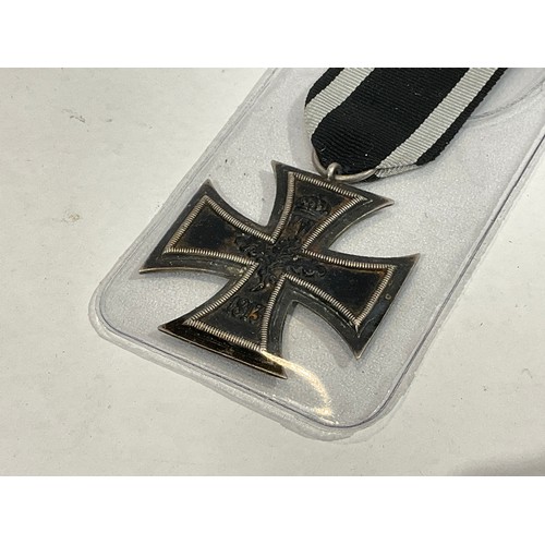 5382 - A German Iron Cross together with a selection of documents. Buyer to determine age of medal.   (C)