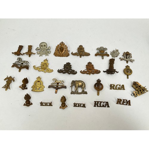 5417 - A collection of British cap badges, mainly artillery and mounted regiments, including 11th Hussars