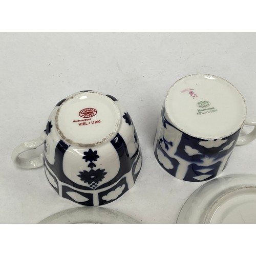 5450 - Two WWII German Kriegsmarine U-Boat blue and white porcelain cups and saucers, one set marked with e... 