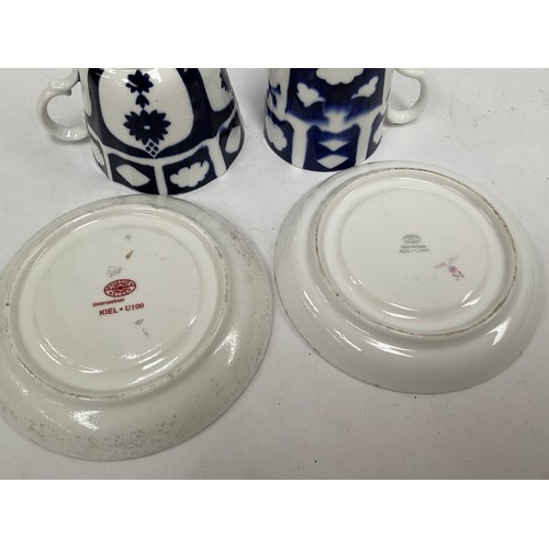 5450 - Two WWII German Kriegsmarine U-Boat blue and white porcelain cups and saucers, one set marked with e... 