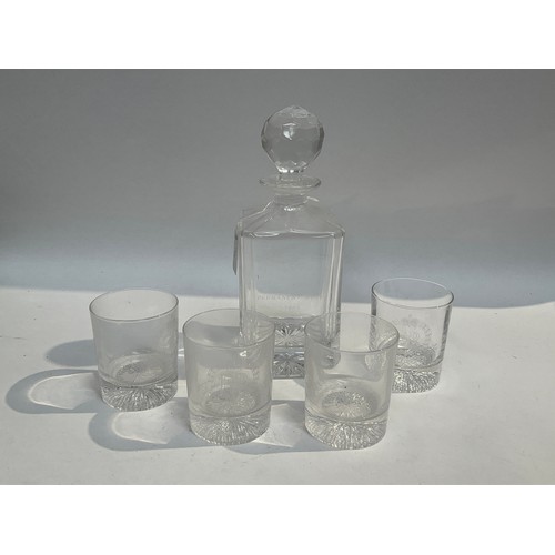 5456 - An Elizabeth II Royal Military Police glass decanter together with four whisky tumblers also engrave... 