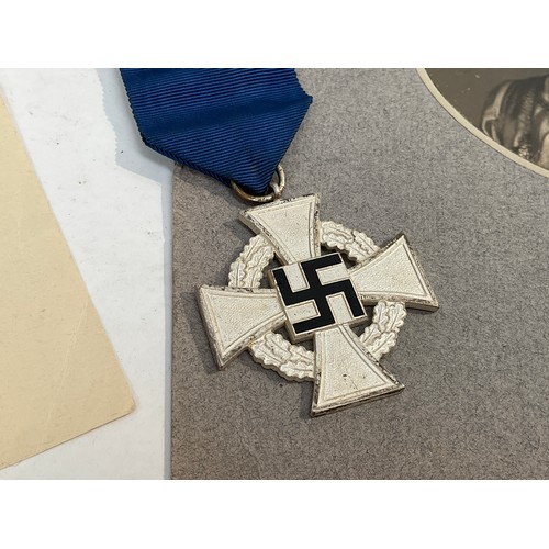 5463 - A German 25 Year Faithful Service Medal with selection of documents including award scroll and photo... 