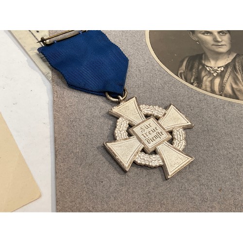 5463 - A German 25 Year Faithful Service Medal with selection of documents including award scroll and photo... 