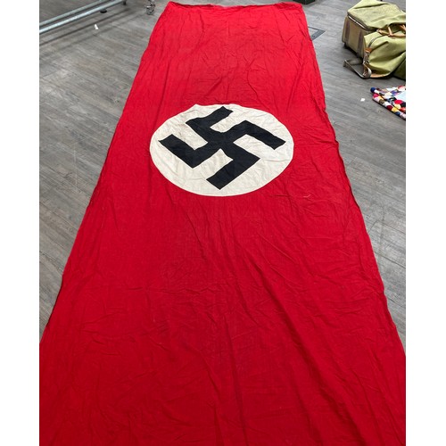 5493 - A Third Reich era German Nazi banner, hung vertically, with central swastika on a white circle, red ... 