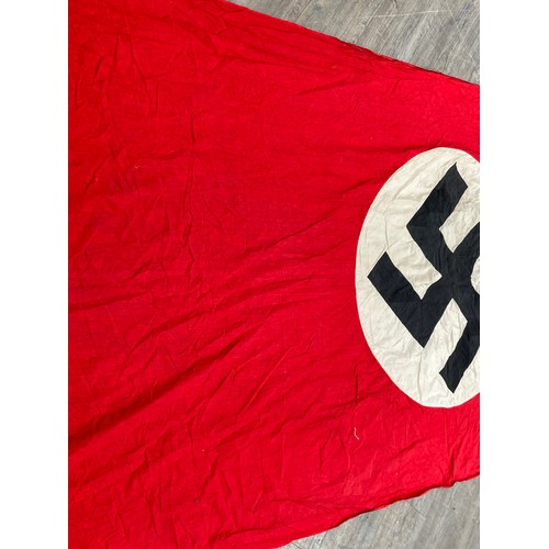 5493 - A Third Reich era German Nazi banner, hung vertically, with central swastika on a white circle, red ... 