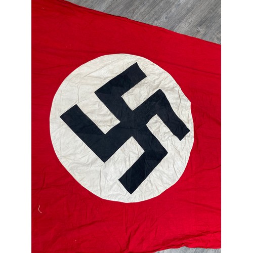 5493 - A Third Reich era German Nazi banner, hung vertically, with central swastika on a white circle, red ... 