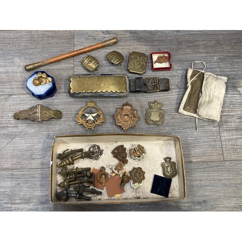 5496 - A collection of badges and insignia, horse brass and accessories including shortened swagger stick.