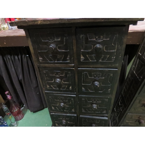 4004 - A small carved African wooden chest of eight drawers, 84cm high x 46cm wide, together with another t... 