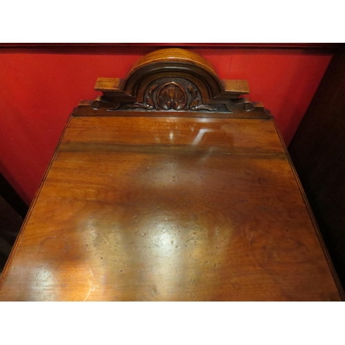 4039 - A late Victorian carved raised back walnut and burr walnut bedside cabinet the single door over a pl... 