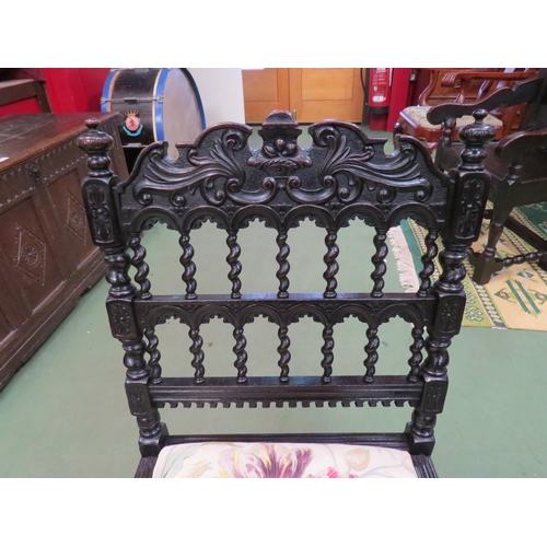 4056 - A Victorian oak chair with acanthus leaf and fruit bowl decoration the finial top over spiral twist ... 