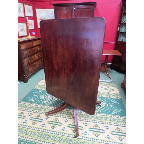 4061 - Circa 1800 a mahogany tilt top table, the reeded edge top over a turned column and outswept legs on ... 