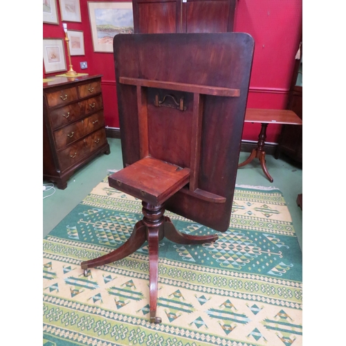 4061 - Circa 1800 a mahogany tilt top table, the reeded edge top over a turned column and outswept legs on ... 