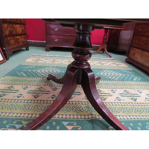 4061 - Circa 1800 a mahogany tilt top table, the reeded edge top over a turned column and outswept legs on ... 