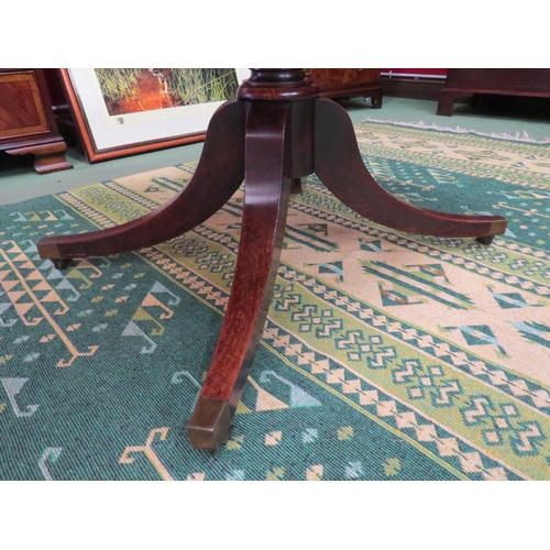 4061 - Circa 1800 a mahogany tilt top table, the reeded edge top over a turned column and outswept legs on ... 