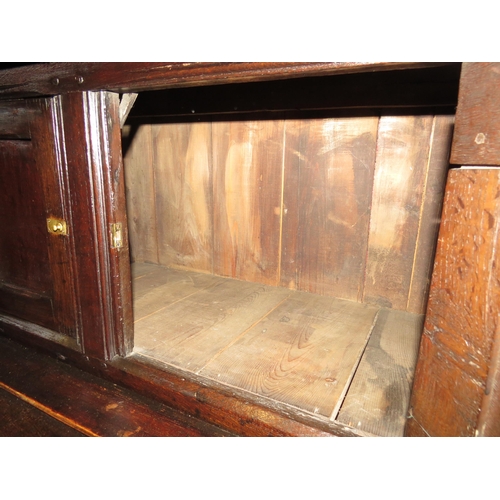 4117 - A Circa 1700 English pegged oak court cupboard with unusual bank of nine cupboard panelled doors hav... 