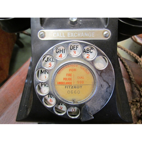 4167 - A vintage black bakelite telephone resting upon a plinth containing bells