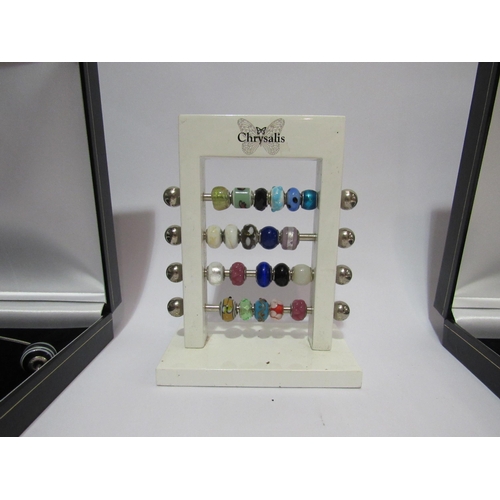 4311 - Two charm bead necklaces, three bracelets and bead display stand