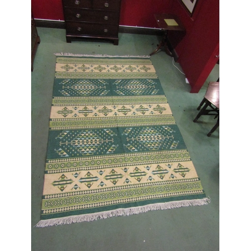 4409 - A green and cream Kilim rug decorated with geometric patterns, tasselled ends, 300cm x 200cm    (E) ... 