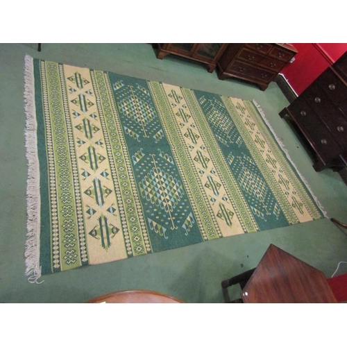 4409 - A green and cream Kilim rug decorated with geometric patterns, tasselled ends, 300cm x 200cm    (E) ... 