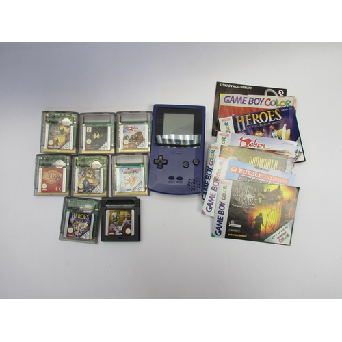 7023 - A Nintendo Game Boy Color handheld computer games console with instruction booklet and eight games a... 