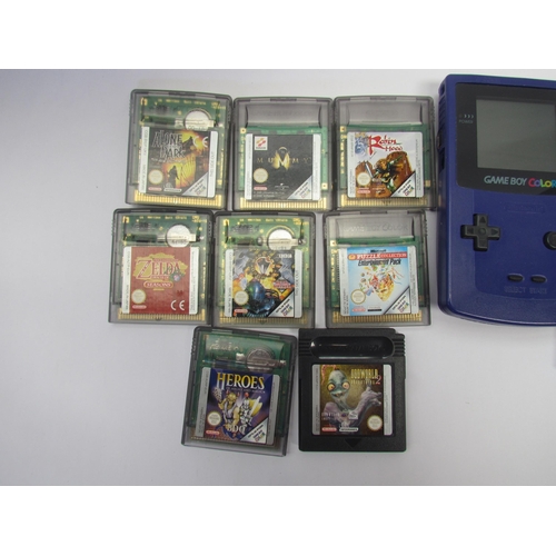 7023 - A Nintendo Game Boy Color handheld computer games console with instruction booklet and eight games a... 